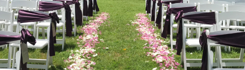 Chairs set up for a wedding with flowers down the isle