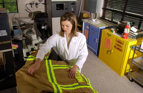 Student in a lab testing an article of clothing/uniform